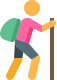 Hiker carrying a backpack holding a walking stick